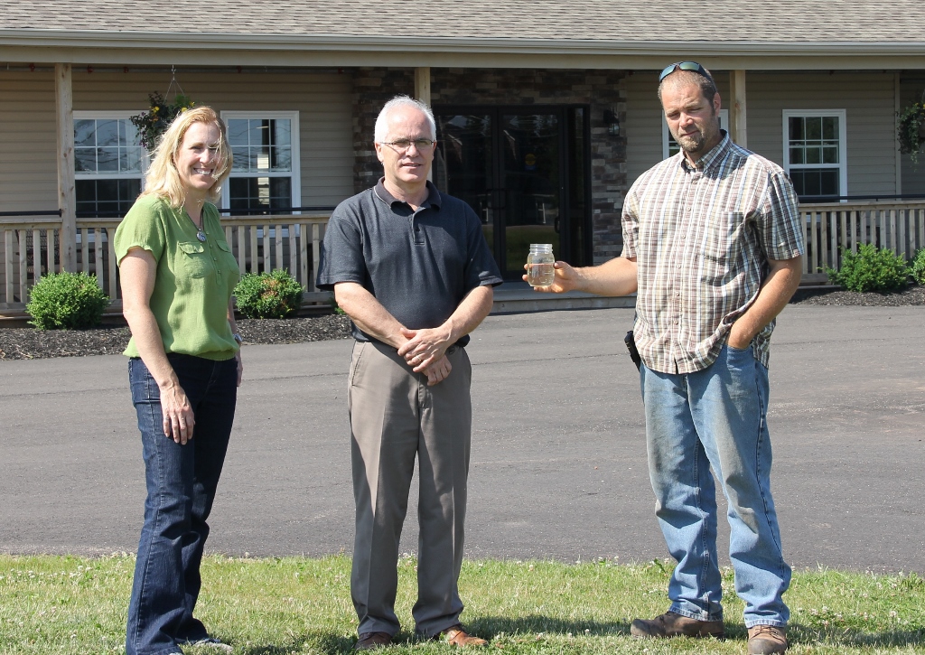 Kelly Galloway with Owner, Alan MacPhee, and septic installer, Philip Clark (holding bottle of clear effluent)